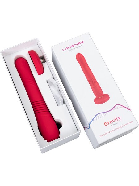Red electronic device with 'Gravity' branding in open packaging on a white background