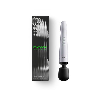 The packaging of the Doxy Die Cast Max Cordless with USB-C charging cable - Adult Toys - Vibrators - Wands - Danish Blue Adult Centres - Doxy massager is shown next to its black packaging box with green branding on a clean white background - Danish Blue Adult Centres